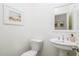 Modern powder room with pedestal sink and toilet at 4841 E Amelia Ave, Phoenix, AZ 85018