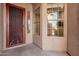 Front entry with red metal door and window at 5077 S Barley Way, Gilbert, AZ 85298