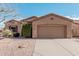 One-story house with a two-car garage and desert landscaping at 5077 S Barley Way, Gilbert, AZ 85298