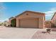 Front view of a tan house with a two-car garage at 5077 S Barley Way, Gilbert, AZ 85298