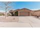 Single-story home with desert landscaping and two-car garage at 5077 S Barley Way, Gilbert, AZ 85298