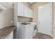 Laundry room with washer, dryer, and upper cabinets at 5077 S Barley Way, Gilbert, AZ 85298