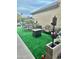 Cozy backyard patio featuring modern outdoor furniture and lush synthetic grass at 5131 W Fairview St, Chandler, AZ 85226