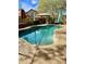 Backyard pool with covered outdoor dining area, lounge seating, and mature landscaping at 5131 W Fairview St, Chandler, AZ 85226