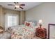 Bedroom with floral bedding, nightstand and ceiling fan at 5350 E Deer Valley Dr # 4248, Phoenix, AZ 85054