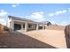 Large backyard with a covered patio and a retaining wall; perfect for entertaining or relaxation at 6383 W Georgetown Way, Florence, AZ 85132