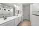 Bathroom with dual vanity sinks, modern fixtures, and a walk-in shower with tile surround at 6383 W Georgetown Way, Florence, AZ 85132