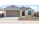 Charming single-story home featuring a two-car garage, tiled roof, and desert landscaping for low maintenance appeal at 6383 W Georgetown Way, Florence, AZ 85132