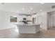 Bright kitchen featuring a central island, stainless appliances, granite countertops, and tile flooring at 6383 W Georgetown Way, Florence, AZ 85132