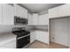 Modern kitchen showcasing white cabinets, granite counters, stainless steel appliances, and tile flooring at 6383 W Georgetown Way, Florence, AZ 85132