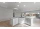 Spacious kitchen island featuring granite countertops, white cabinets, and recessed lighting, creating a bright and modern space at 6383 W Georgetown Way, Florence, AZ 85132