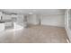 Bright, open-concept living space featuring tile floors and ample natural light, connecting the kitchen and living areas at 6383 W Georgetown Way, Florence, AZ 85132