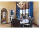 Well-appointed dining area with chandelier, bay windows with views, and a round dining table at 7500 E Mccormick Pkwy # 19, Scottsdale, AZ 85258