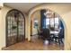 Elegant dining area featuring a chandelier, bay windows, and an arched doorway at 7500 E Mccormick Pkwy # 19, Scottsdale, AZ 85258