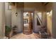 Inviting entrance featuring a pivot door leading to a foyer with tiled flooring and a staircase at 7500 E Mccormick Pkwy # 19, Scottsdale, AZ 85258