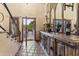 Foyer with tiled floor, wooden console, wrought iron banister, and view to outdoors at 7500 E Mccormick Pkwy # 19, Scottsdale, AZ 85258