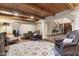 Spacious living room with wood ceiling, columns, decorative rugs, and a glimpse of the staircase at 7500 E Mccormick Pkwy # 19, Scottsdale, AZ 85258