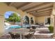 Covered outdoor area with seating near a pool and beautiful landscaping views at 7500 E Mccormick Pkwy # 19, Scottsdale, AZ 85258