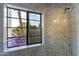 Shower area featuring colorful tile and a window with a serene outdoor view at 7500 E Mccormick Pkwy # 19, Scottsdale, AZ 85258