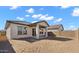 View of the home's covered patio with a dirt yard and block wall at 7548 W Park St, Laveen, AZ 85339