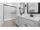 Elegant bathroom featuring dual sinks, framed mirrors, and a glass-enclosed shower at 7548 W Park St, Laveen, AZ 85339