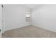 Light-filled bedroom with neutral carpet, bright white walls, and a window at 7548 W Park St, Laveen, AZ 85339