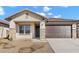 Inviting single-story home with stone accents, desert landscaping, and a covered entry at 7548 W Park St, Laveen, AZ 85339