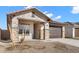 Charming single-story home with desert landscaping, stone accents, and a two-car garage at 7548 W Park St, Laveen, AZ 85339