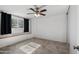 Bedroom with tiled floor, window seat, and black curtains at 8344 E Indianola Ave, Scottsdale, AZ 85251