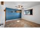 Bright bedroom with tiled floor, blue accent wall and built-in shelves at 8344 E Indianola Ave, Scottsdale, AZ 85251