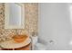 Stylish powder room showcasing a wood vessel sink, mosaic tile accent wall, and modern fixtures at 8606 S 30Th St, Phoenix, AZ 85042