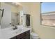 Well lit bathroom with neutral colors and a large mirror above the counter at 8606 S 30Th St, Phoenix, AZ 85042