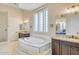 Luxurious bathroom features a soaking tub, dual vanities, and a separate glass shower at 8606 S 30Th St, Phoenix, AZ 85042