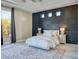 Bedroom with wood accent wall, neutral colors, and a large window with neighborhood views at 8606 S 30Th St, Phoenix, AZ 85042