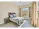 Light bedroom with a view featuring statement headboard and neutral walls at 8606 S 30Th St, Phoenix, AZ 85042