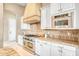 Close-up of the custom kitchen showcasing the stainless steel appliances, hood, and granite countertops at 8606 S 30Th St, Phoenix, AZ 85042