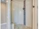 Walk-in shower featuring glass enclosure, neutral tile, and stone floor at 8606 S 30Th St, Phoenix, AZ 85042