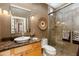 Beautiful bathroom featuring marble counters, decorative mirror, and glass enclosed shower at 8923 E Mountain Spring Rd, Scottsdale, AZ 85255