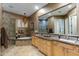 Elegant bathroom featuring a glass shower, soaking tub, double sinks, and stylish chandelier at 8923 E Mountain Spring Rd, Scottsdale, AZ 85255