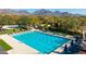 Aerial view of a large community lap pool with lounge chairs and well-manicured landscaping at 8923 E Mountain Spring Rd, Scottsdale, AZ 85255