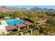 Aerial view of a community lap pool and basketball court, surrounded by lush landscaping at 8923 E Mountain Spring Rd, Scottsdale, AZ 85255