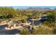 Community entrance with desert landscaping, stone walls and wooden entry gates at 8923 E Mountain Spring Rd, Scottsdale, AZ 85255