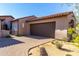 Charming home featuring a two-car garage, brick driveway and southwestern architectural design elements at 8923 E Mountain Spring Rd, Scottsdale, AZ 85255