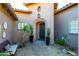 Charming front entrance featuring an arched doorway and desert landscaping at 8923 E Mountain Spring Rd, Scottsdale, AZ 85255