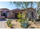 Exterior view of a single-story home with desert landscaping and a three-car garage at 8923 E Mountain Spring Rd, Scottsdale, AZ 85255