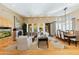 Beautiful open-plan living room featuring hardwood floors, fireplace, dining area and bright windows at 8923 E Mountain Spring Rd, Scottsdale, AZ 85255