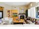 Cozy living room with a fireplace, built-in cabinets, and plenty of natural light at 8923 E Mountain Spring Rd, Scottsdale, AZ 85255