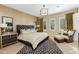 Stylish main bedroom featuring a tufted headboard, designer accents, and a cozy sitting area at 8923 E Mountain Spring Rd, Scottsdale, AZ 85255