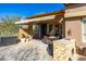 Charming covered patio with dining table and seating, plus an outdoor sink for entertaining at 8923 E Mountain Spring Rd, Scottsdale, AZ 85255