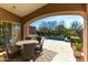 Inviting covered patio with an outdoor dining area overlooking the pool at 8923 E Mountain Spring Rd, Scottsdale, AZ 85255